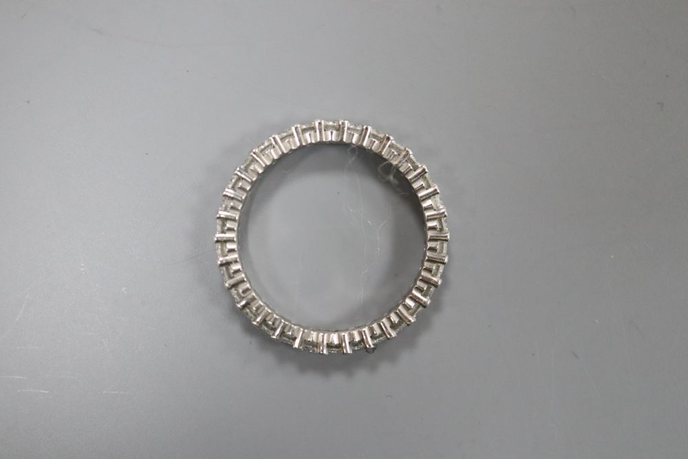 A platinum and diamond full eternity ring, claw-set with small round diamonds, size N, gross 2.8 grams.